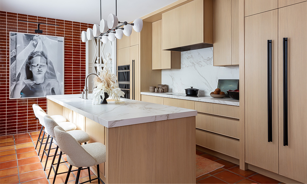 A modern one-wall kitchen featuring light-toned wood veneer cabinets and a central countertop island. The light wood finish brings a warm and natural touch to the space, creating a cozy and inviting atmosphere. The central island offers extra workspace and serves as a stylish focal point, while the overall design highlights clean lines, simplicity, and a harmonious balance of natural materials.