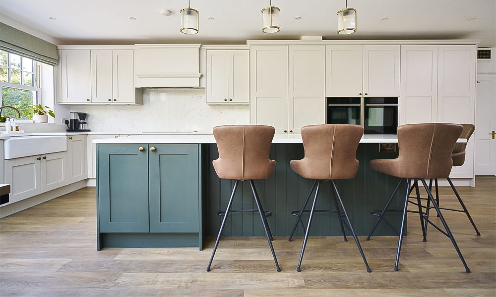 A contemporary L-shaped kitchen featuring white cabinetry and a striking green central island. The crisp white cabinets offer a clean, bright backdrop, while the vibrant green island adds a bold, refreshing pop of color. The layout enhances both functionality and aesthetics, providing ample counter space for meal preparation and a stylish area for socializing or casual dining. The modern design seamlessly blends neutral tones with the lively green accent, creating an inviting and dynamic kitchen environment.