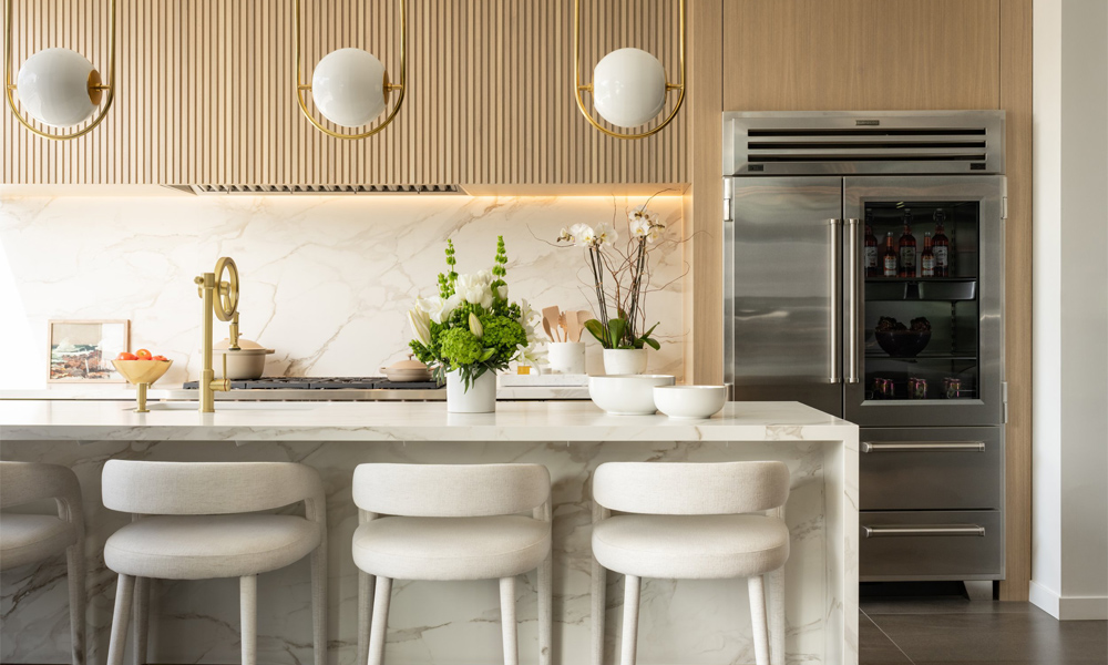 A contemporary one-wall kitchen featuring light wood veneer cabinets and a white central island. The kitchen's clean design showcases the soft, natural grain of the light wood, which contrasts beautifully with the sleek white island. The island serves as both a cooking area and a gathering spot, enhancing the kitchen's functionality and modern aesthetic. The overall look is fresh, inviting, and stylish, with a focus on simplicity and natural textures.
