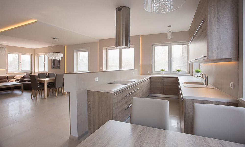 A U-shaped kitchen featuring wood veneer cabinetry. The warm, natural wood tones add a cozy and inviting feel, while the U-shaped layout maximizes counter space and storage, creating a functional and aesthetically pleasing kitchen design.