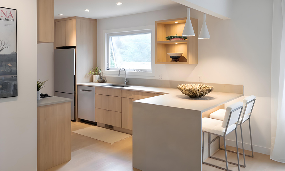 A contemporary kitchen featuring wood veneer cabinets and a white central island. The natural warmth of the wood cabinets contrasts beautifully with the sleek, bright white island, creating a harmonious balance of style and functionality in the modern kitchen design.