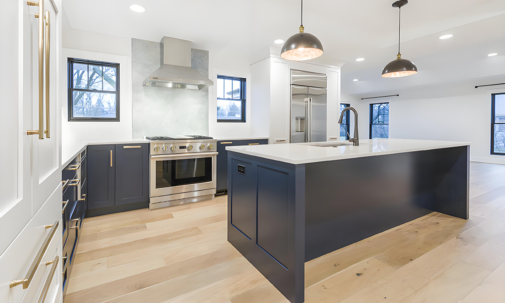 A modern kitchen featuring high-gloss cabinetry with white upper cabinets and black lower cabinets and island. The sleek black and white contrast creates a bold, contemporary look, while the minimalist design offers a functional and stylish space.