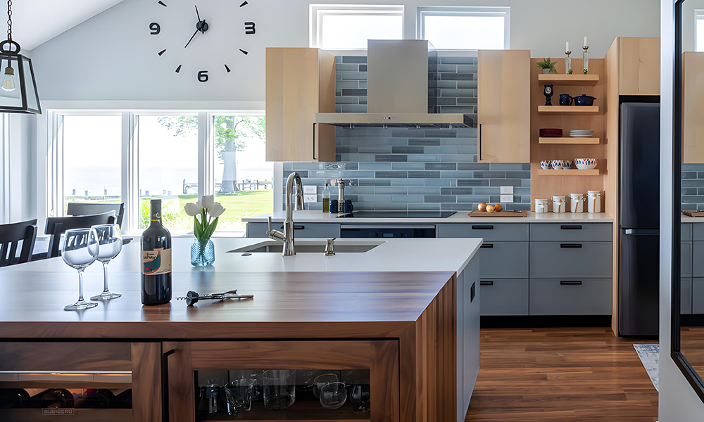 A close-up view of an L-shaped kitchen featuring wood veneer cabinets and gray lower cabinetry. The warm wood tones of the upper cabinets contrast with the sleek, modern gray of the lower cabinets, creating a stylish and functional design that enhances the kitchen's contemporary feel.