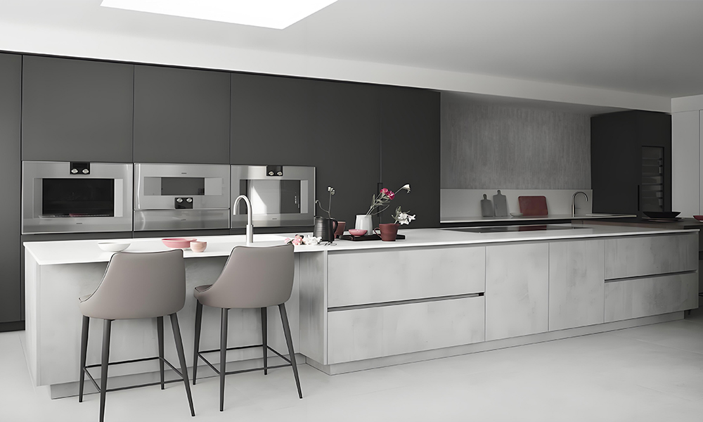 A one-wall kitchen featuring cabinetry in a sleek black, white, and gray color scheme, with a central island. The contrasting colors create a bold, modern look, while the island enhances the kitchen's functionality and serves as a stylish centerpiece in the minimalist layout.