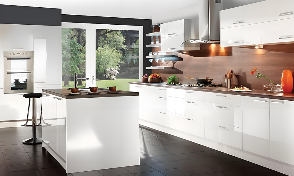 A one-wall kitchen with white lacquered cabinetry and a central island. The glossy white finish creates a bright and modern atmosphere, while the island serves as both a functional workspace and a stylish centerpiece in the open layout.