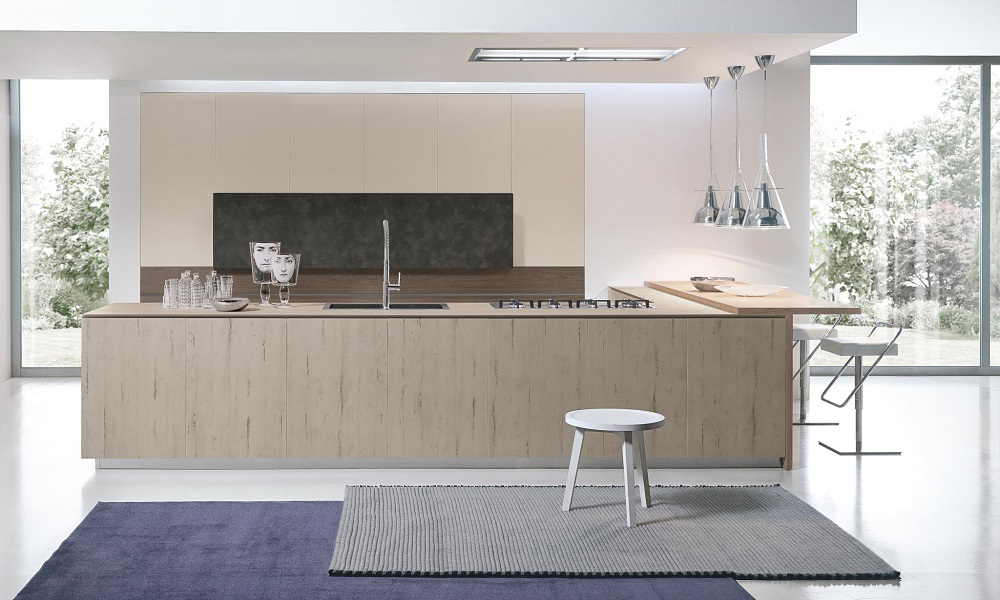 A contemporary kitchen featuring light wood veneer cabinets and a central island. The soft wood tones bring warmth to the space, while the island adds both functionality and a stylish focal point, creating a balanced and inviting atmosphere.
