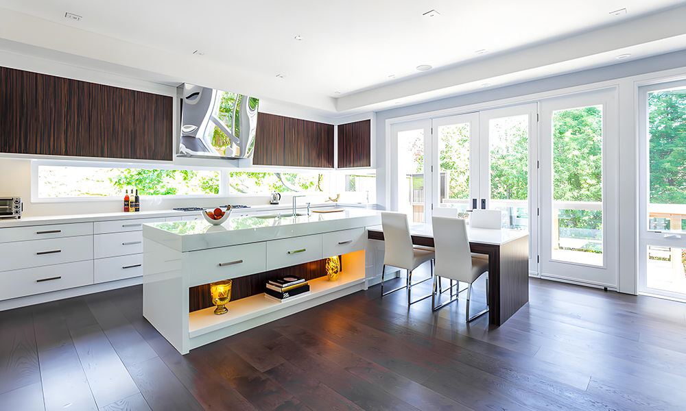 A contemporary kitchen with white lower cabinetry and wood veneer upper cabinets, complemented by a wood veneer central island. The combination of white and natural wood tones creates a warm, balanced atmosphere, with the island serving as a functional and stylish focal point in the space.
