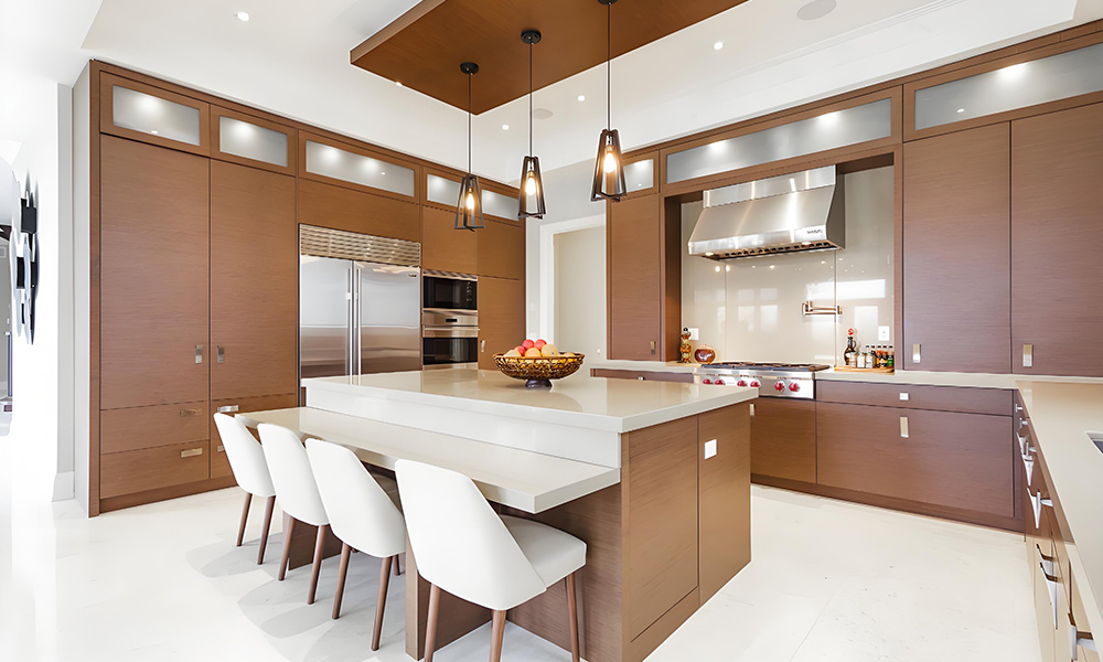 A side view of a modern kitchen with wood veneer cabinets, offering a natural, warm aesthetic. The central island serves as a functional centerpiece, complementing the rich wood textures and creating a stylish and inviting atmosphere.