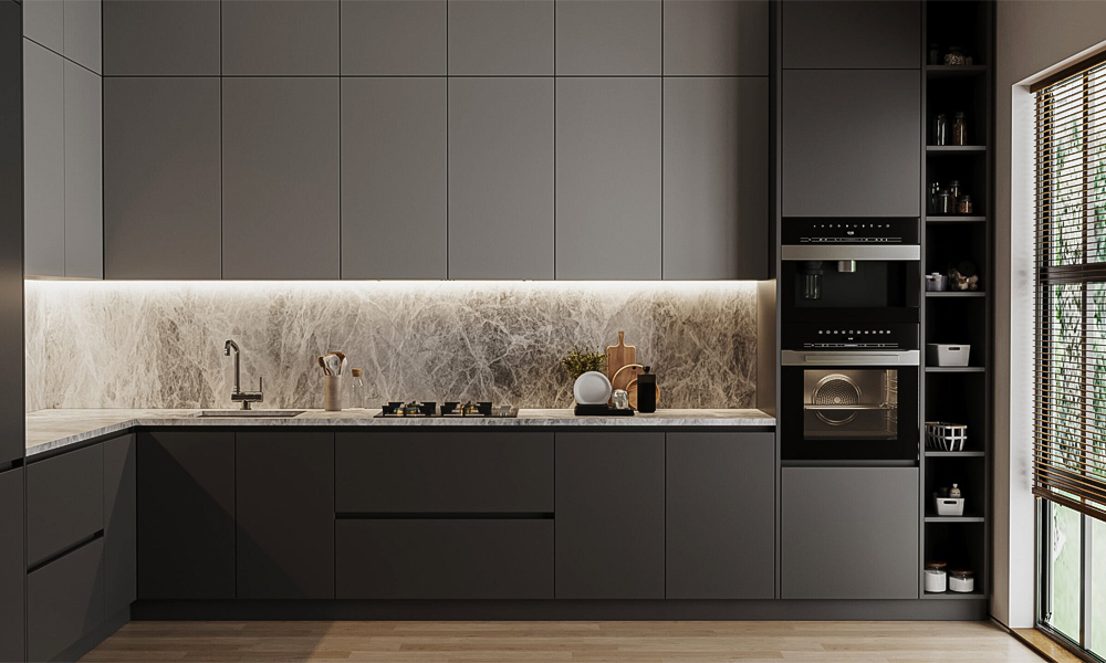 A close-up view of an L-shaped kitchen with gray-toned cabinets, showcasing a modern and refined design. The cabinetry features clean lines and smooth finishes, emphasizing a sleek, minimalist aesthetic. The gray color palette creates a calm and sophisticated atmosphere.