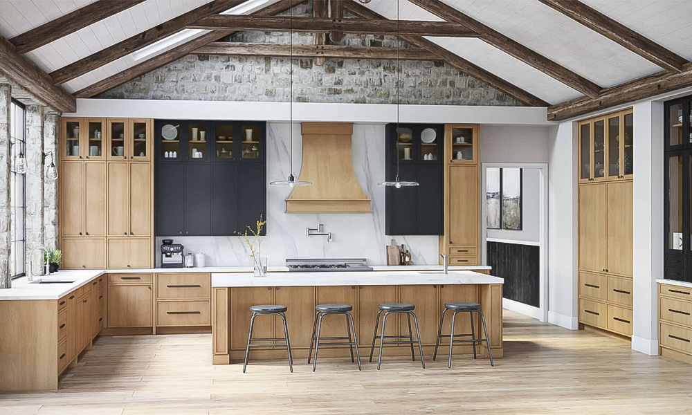 A spacious, modern kitchen with a rustic touch, featuring exposed wooden beams on a vaulted ceiling and a stone accent wall. The cabinetry combines light natural wood with sleek matte black finishes, complemented by white marble countertops. A large central island with four industrial-style metal stools anchors the space. Glass-front upper cabinets display dishes, and pendant lights hang over the island. The room has a warm, airy feel with ample natural light from large windows.