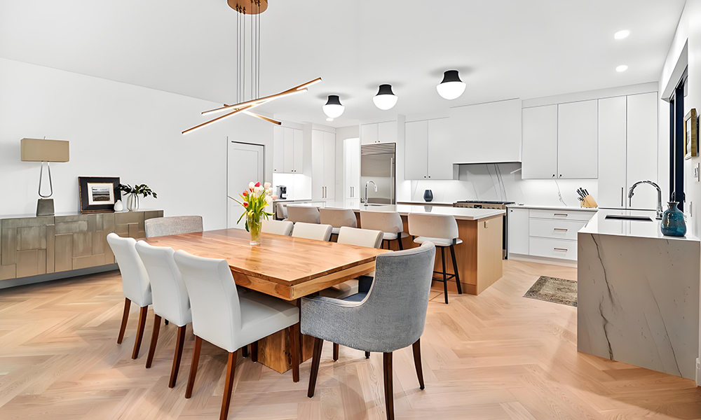 A modern kitchen with white lacquered cabinets in a straight layout, featuring a central island as the centerpiece. The minimalist design highlights the smooth, glossy finish of the cabinetry, which complements the clean lines and open space of the kitchen. The island provides both additional storage and a spacious workspace, enhancing the functionality of the area while maintaining a bright, sleek aesthetic. The overall look is clean, contemporary, and well-suited for a modern home.