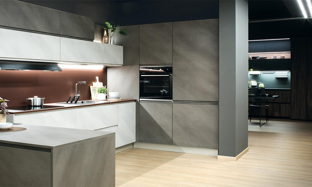 A U-shaped kitchen featuring gray and white lacquer cabinets, offering a modern and stylish atmosphere. The combination of soft gray and crisp white finishes creates a fresh, elegant contrast, while the glossy lacquer surfaces reflect light to enhance the kitchen’s spacious feel. The U-shaped layout maximizes workspace and storage, making it both beautiful and highly functional.