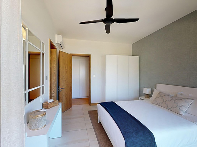 Project case image for Manta Cove by Horizon Holidays, located in Mauritius. The image features a beautifully designed guest room, showcasing modern furnishings, soft lighting, and a serene color palette. The space is both elegant and inviting, offering a comfortable and luxurious atmosphere for guests to relax and unwind.