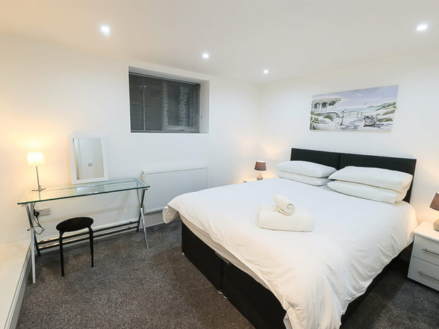 Project case image for Lace Market Point, located in the UK. The bedroom interior features a modern, stylish design with sleek furnishings. The room showcases a harmonious blend of light tones, including a comfortable bed, minimalist decor, and a spacious wardrobe, creating a serene and contemporary atmosphere.