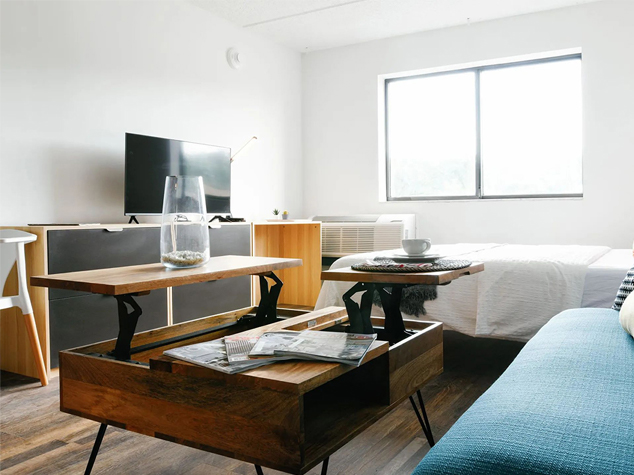 Project case image for an apartment project located at 275 Research Parkway in Meriden, USA. The guest room scene features a modern and inviting design with a comfortable bed, stylish furnishings, and soft, neutral tones. The space is thoughtfully arranged to create a warm, welcoming, and functional atmosphere for guests.