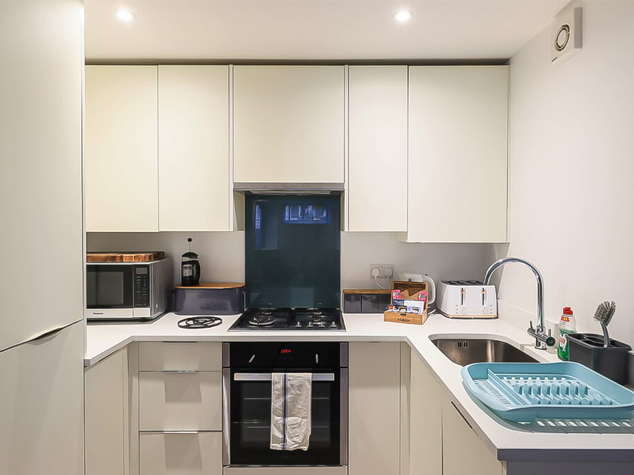 Project case image for Lace Market Point, located in the UK. The image features a display of high-quality cabinetry with a modern design. The cabinets are finished in a sleek white lacquer, offering a clean and minimalist look. The elegant layout maximizes storage while maintaining a sophisticated, contemporary aesthetic.