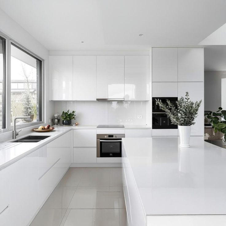 White Kitchen Cabinet with black handles and black faucet