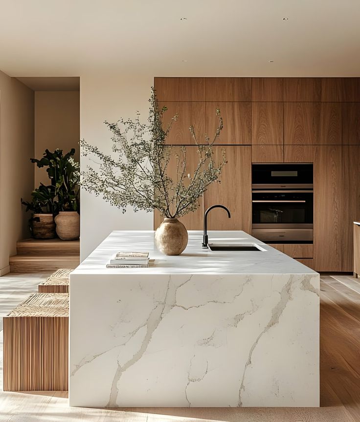 Sintered stone countertops with marble-like texture in a bright modern kitchen.