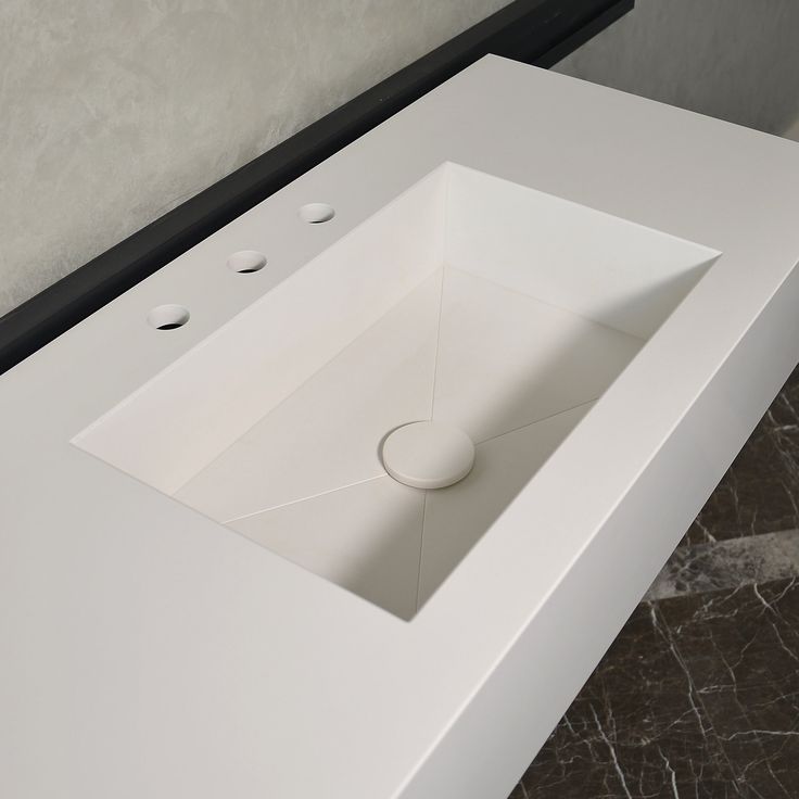 White solid surface countertops with seamless sink integration.