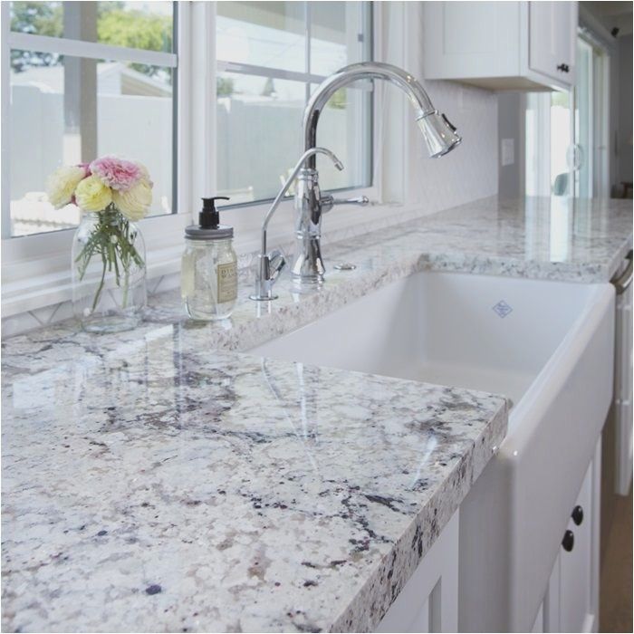 Modern white quartz countertops with subtle grey veining in a bright family kitchen.