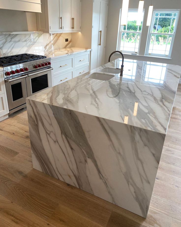 Porcelain countertops in large slab format with matte stone pattern.